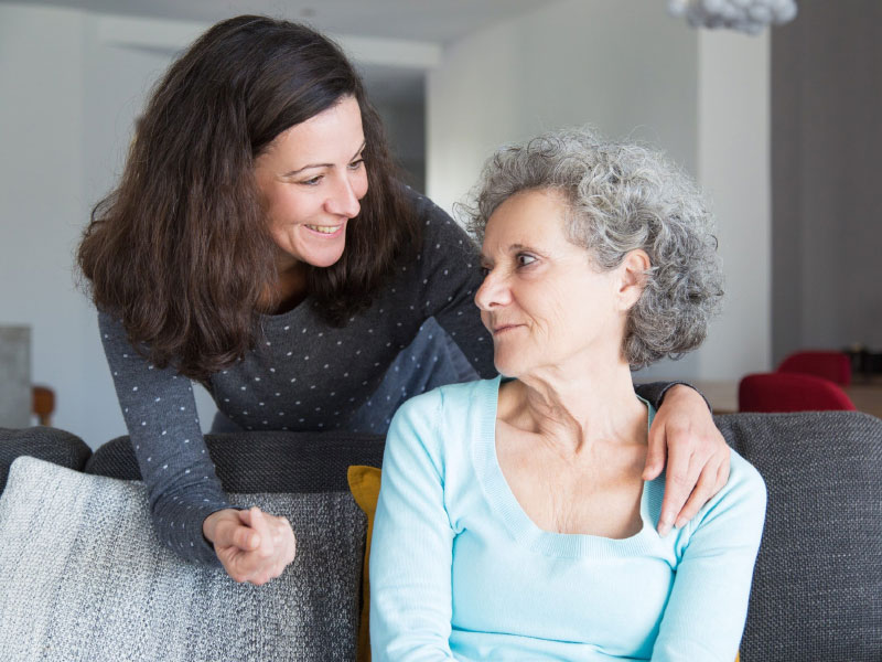 Woman supporting older woman after mesothelioma diagnosis