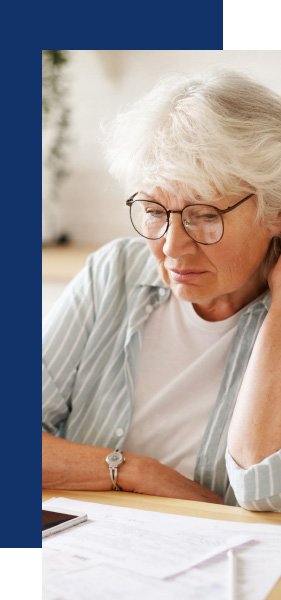 Older woman reviewing asbestos disease claim paperwork