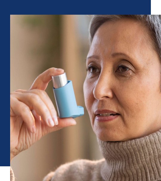 Woman using inhaler for asbestos lung disease symptoms