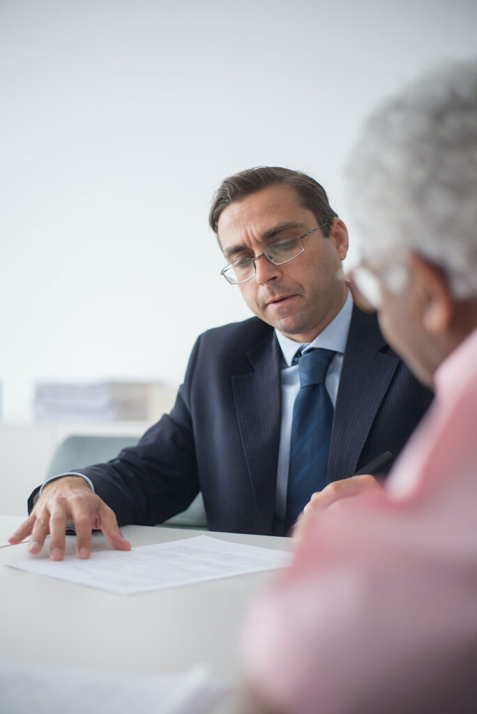 Solicitor discussing asbestos claim documents with client