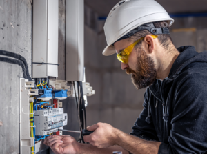 Photo of builder fixing an electric socket in a building